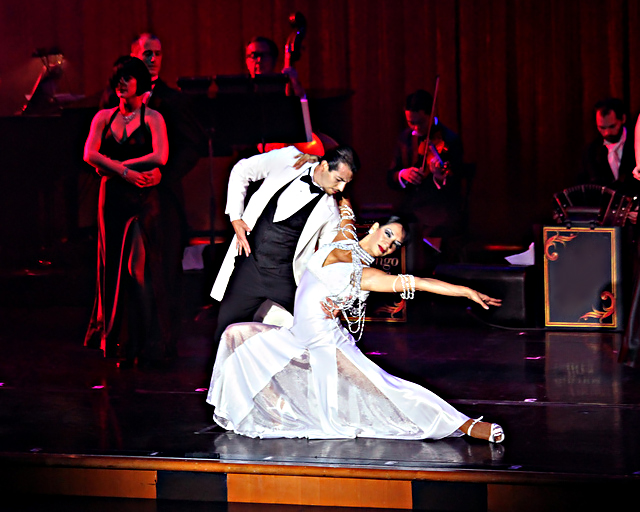 Couple in tango finale in white